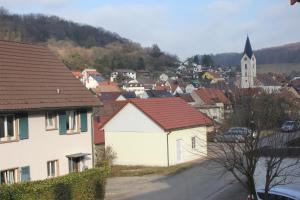 a small town with houses and a church at kleine Ferienwohnung in Inzlingen