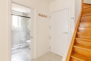 a bathroom with a shower and a toilet and a staircase at Duplex in Durango's old town in Durango +18 photos