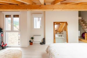 a bedroom with a large bed and a mirror at Duplex in Durango's old town in Durango