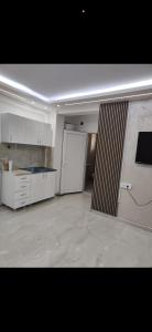 a large room with a kitchen with white cabinets at melvina LUX in Pančevo