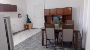 a dining room with a table and chairs and a kitchen at Casa Dept Alquila dia in Oro Verde