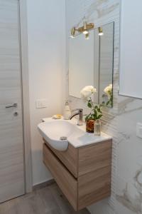 a bathroom with a sink and a mirror at Santa Rosa Relais in Conca dei Marini +57 photos