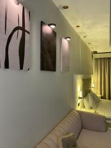 a living room with a couch in front of a bed at شقه in Ar Rass