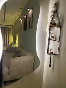 a living room with a couch and a bedroom at شقه in Ar Rass