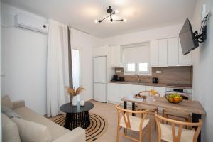 a kitchen and living room with a table and a couch at Aurora Horizon Naxos in Glinádhon +15 photos