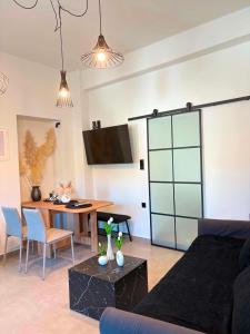 a living room with a couch and a table at Alegria Suite in Ermoupoli