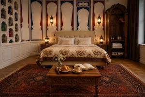 a bedroom with a large bed and a table with a table sidx sidx at Chorminor 1 min to Bukhara Old Town GET EARLY CHECK IN AND LATE CHECK OUT in Bukhara