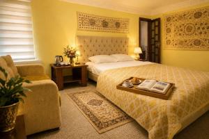 a bedroom with a bed with a tray of books at Chorminor 1 min to Bukhara Old Town GET EARLY CHECK IN AND LATE CHECK OUT in Bukhara