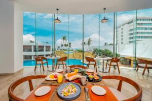 a dining room with a table with food on it at Krystal Grand Cancun All Inclusive in Cancún