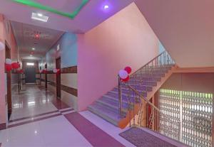 a staircase in a building with red and white balloons at Super Hotel O Surya Inn in Varanasi