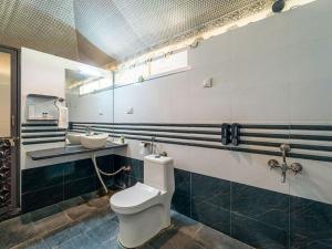 a bathroom with a toilet and a sink at Yatra Desert Camp & Resort in Jaisalmer