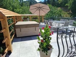 a patio with a table and an umbrella at Murka Holiday Home in Bled +58 photos