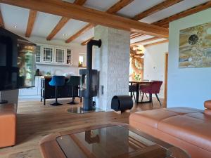 a living room with a couch and a fireplace at Murka Holiday Home in Bled