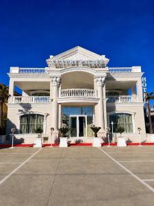 a large white building with a lot of windows at Hotel Luxury Palace in Ishull-Lezhë