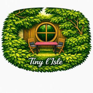 a picture of a tiny house with a table and chairs at Tiny Isle in L'Isle-sur-la-Sorgue