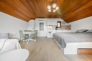 a bedroom with a bed and a table with chairs at Apartmán Pure Harmony in Velké Bílovice