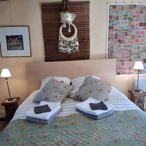 a bedroom with a bed with two pillows on it at Jardin et Hotel Particulier in Bayeux