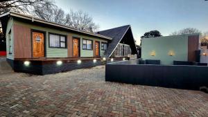a house with a brick driveway in front of it at Blairgowrie Skyline in Johannesburg