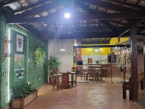 a restaurant with tables and chairs in a room at Espaço Gozzoli, Cantinho da Nonna in Espirito Santo Do Pinhal