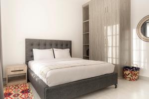 a bedroom with a large bed and a mirror at Githima Cottage 10 at Swara Ranch in Nanyuki +43 photos