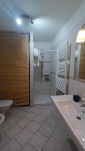 a bathroom with a shower and a toilet and a sink at Casa SAN FELICE in Mori +41 photos