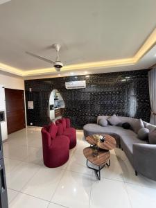 a living room with two couches and a table at ELYSIUM TOWER- One Bedroom Luxury Apartment With Balcony & City View OPP Centaurus Mall Islamabad in Islamabad