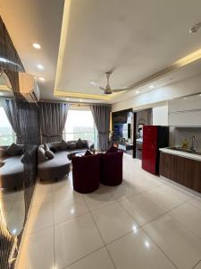 a living room with a couch and a kitchen at ELYSIUM TOWER- One Bedroom Luxury Apartment With Balcony & City View OPP Centaurus Mall Islamabad in Islamabad +54 photos