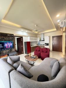 a living room with a couch and a table at ELYSIUM TOWER- One Bedroom Luxury Apartment With Balcony & City View OPP Centaurus Mall Islamabad in Islamabad