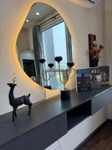 a room with a mirror and a shelf with trophies at ELYSIUM TOWER- One Bedroom Luxury Apartment With Balcony & City View OPP Centaurus Mall Islamabad in Islamabad