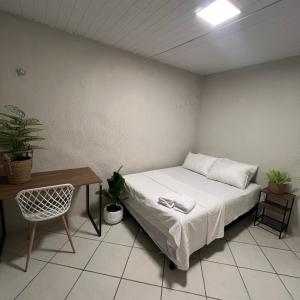 a bed in a room with a table and a bed sidx sidx sidx at Brisa Mar in Fortaleza
