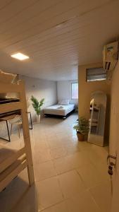 a large room with a bunk bed and a couch at Brisa Mar in Fortaleza