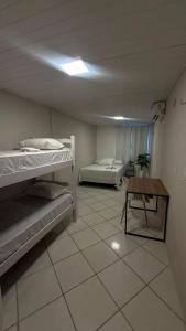 a room with two bunk beds and a table at Brisa Mar in Fortaleza