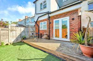 a wooden deck in front of a house at Two bedrooms apartment in Wainscot