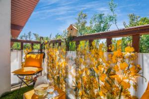 a balcony with a fence with yellow flowers on it at Monet Garden Retreat in Giverny