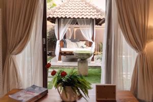 a room with a view of a bed and a window at Villa Lapiz Lazuli - Seminyak Kuta Luxury Private Pool Villas in Seminyak