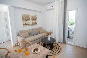 a living room with a couch and a table at Aurora Horizon Naxos in Glinádhon