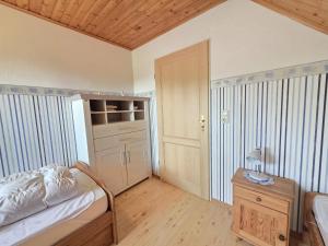 a bedroom with a bed and a table with a lamp at Ferienwohnung Ufen in Hage