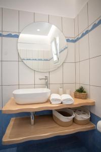 a bathroom with a sink and a mirror at Aurora Horizon Naxos in Glinádhon