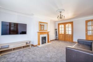 a living room with a couch and a fireplace at DD Private Double Room with Shared Bathroom in York