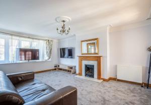 a living room with a couch and a fireplace at DD Private Double Room with Shared Bathroom in York