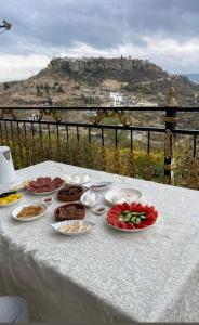 a white table with plates of food on top of it at Sulav amedi in Sūlav