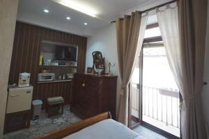 a bedroom with a bed and a balcony with a television at B&b Sant'Agata in Sant'Agata de' Goti