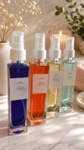 four bottles of perfumes sitting on a table at Mellini Living in Misano Adriatico +17 photos