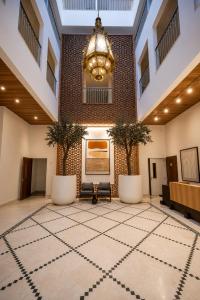 a lobby with a chandelier and a large rug at Royal Rif Tanger Marina Bay in Tangier