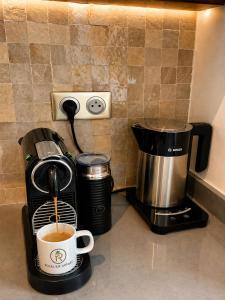 a coffee maker and a cup of coffee on a counter at Royal Rif Tanger Marina Bay in Tangier