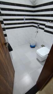 a bathroom with a toilet and a sink at Taj Comfort Inn in Agra +33 photos