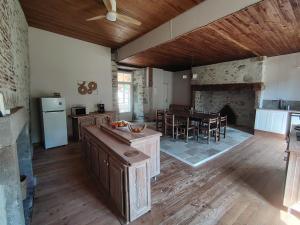 a kitchen and dining room with a table and a fireplace at Lo Castel de Lasmaries in Saint-Parthem +15 photos