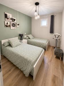 a bedroom with two beds and a window at LE TOURISTIC Appartements T2 et T3 in Luz-Saint-Sauveur