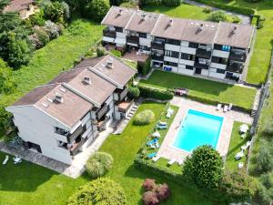 an aerial view of a house with a swimming pool at Prati Escape - Apartment with Pool and Lakeview in Lierna