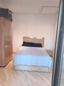 a bedroom with a large bed in a room at Mehdia Beach Apartment in Kenitra